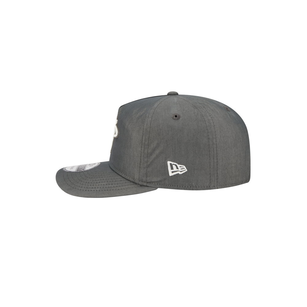 The New Era Miami HEAT Nylon Grey Snapback is shown from the side on a white background, featuring a flat brim, cotton-nylon material, and a white New Era logo embroidered near the back.