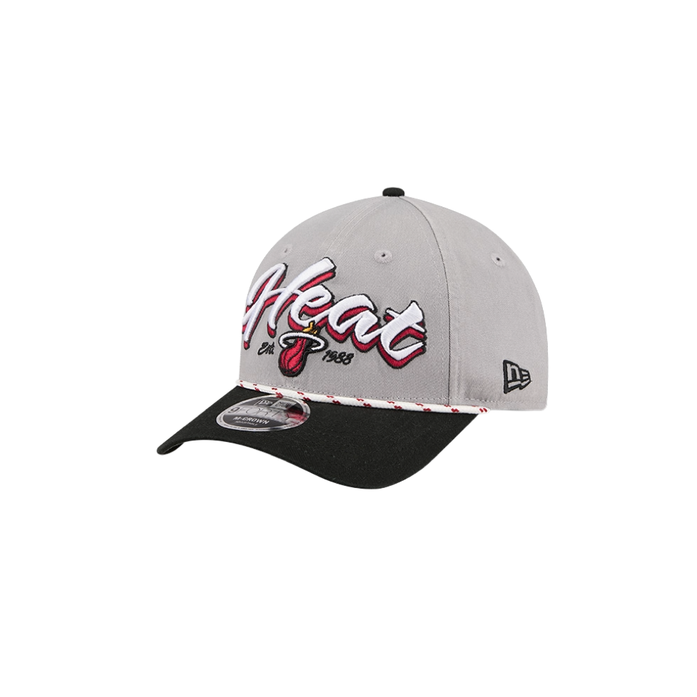 The New Era Miami HEAT Loyal Team Snapback is a gray and black cap with “Heat” in white and red script, team logo, Est. 1988 on the front, A-Frame pinched front, black curved brim, and New Era logo on the side.