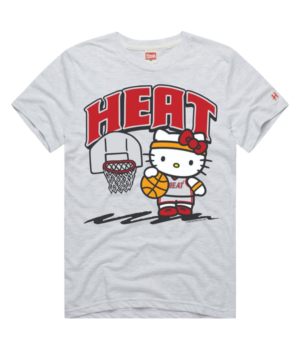The Homage Miami HEAT Hello Kitty Women's Tee is a white polyester, cotton, and rayon shirt featuring Hello Kitty in a basketball uniform holding a basketball by a hoop with 