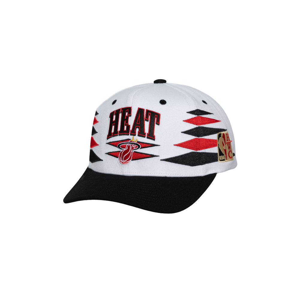 The Mitchell & Ness Miami HEAT Diamond Cut Snapback features white and black polyester, red and black geometric patterns, HEAT text, the team logo on front, NBA patch on the side, and a black brim. One size fits most; spot clean only.