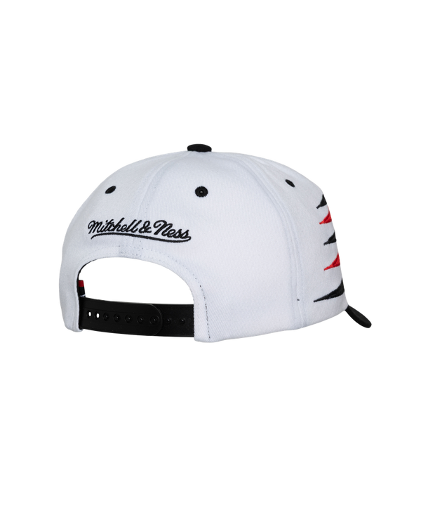 The Mitchell & Ness Miami HEAT Diamond Cut Snapback features white and black polyester, red and black geometric patterns, HEAT text, the team logo on front, NBA patch on the side, and a black brim. One size fits most; spot clean only.