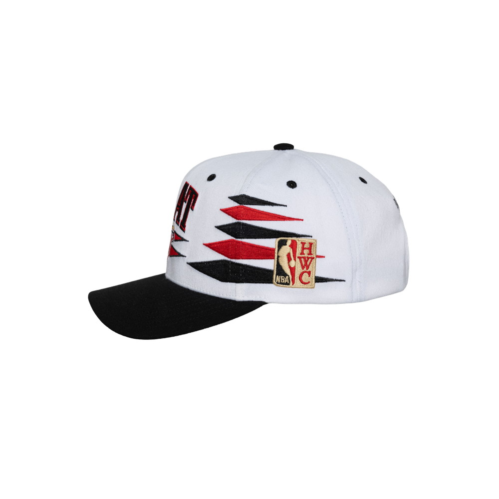 The Mitchell & Ness Miami HEAT Diamond Cut Snapback features a white polyester crown, black brim, black and red zigzag design, NBA Hardwood Classics patch on the side, and an adjustable fit. Spot clean only; one size fits most.