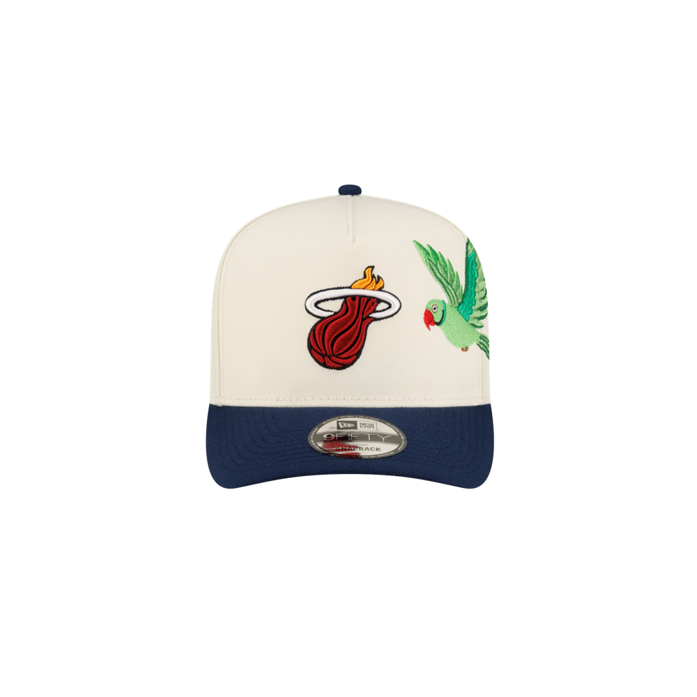 Court Culture x New Era Parakeet snapback hat in cream with a blue brim, featuring an embroidered flaming basketball logo and a green parakeet on the front panels.