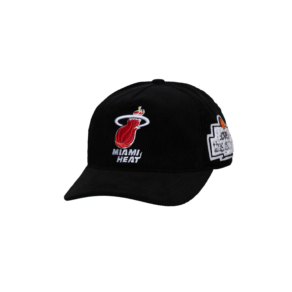 The Mitchell & Ness Miami HEAT 'I Love This Game' Snapback is a black corduroy cotton hat with Miami Heat logo and text on the front, an embroidered side patch, and adjustable fit. Spot clean only. Displayed against a plain white background.