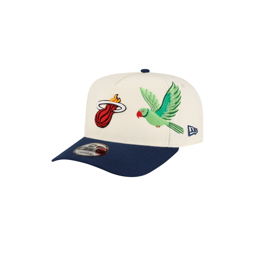 Off-white A-frame Court Culture x New Era Parakeet snapback cap with a navy blue pre-curved brim, featuring an embroidered flaming basketball logo and a green parakeet.