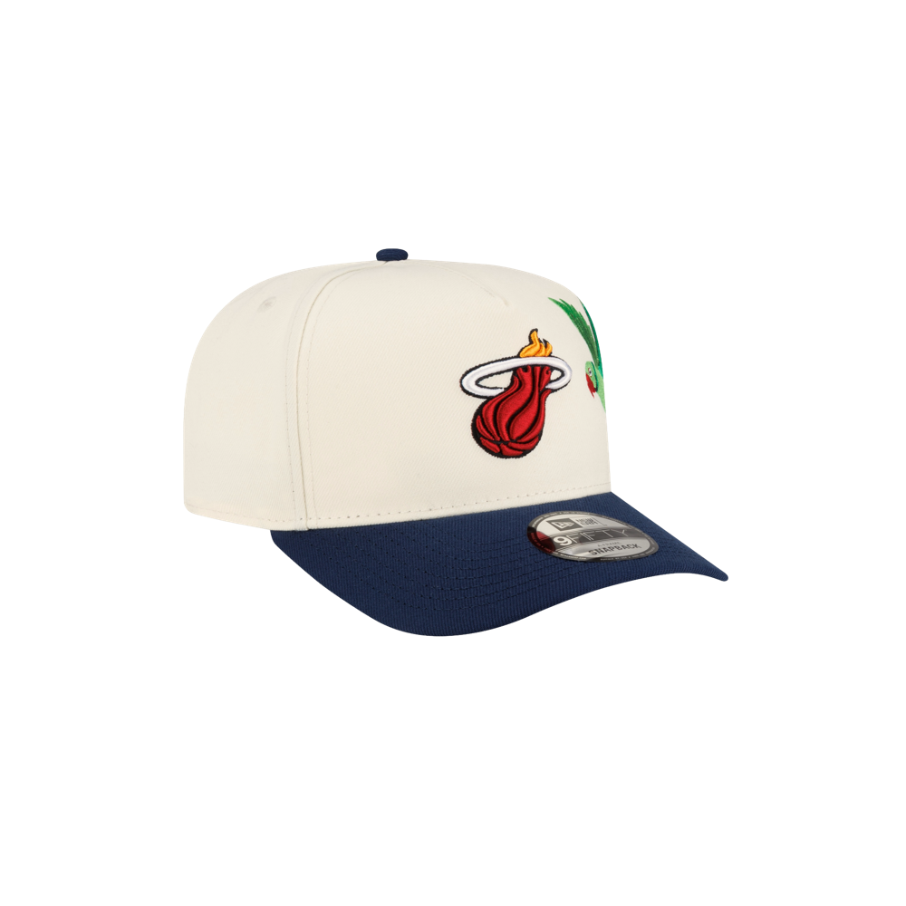 Off-white A-frame Court Culture x New Era Parakeet snapback cap with a navy blue brim, featuring a Miami Heat logo and a parakeet graphic on the side.