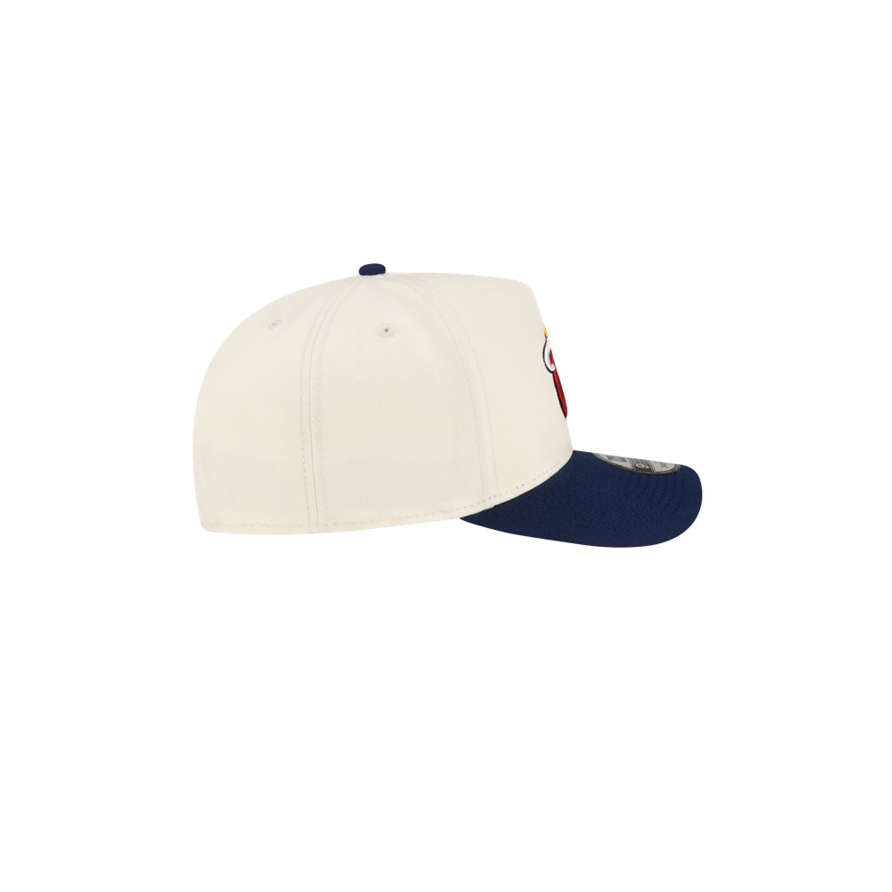 Side view of an off-white Court Culture x New Era Parakeet Snapback with an A-frame design, a navy blue pre-curved brim, and a small team logo on the side.