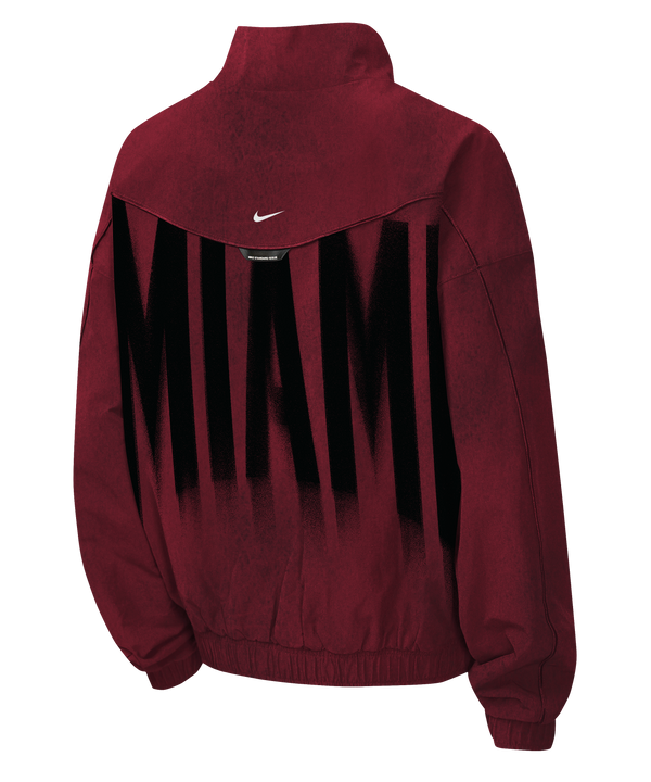 Maroon loose-fit, full-zip Nike Miami HEAT Standard Issue Loud Woven Youth Jacket featuring a large black spray-paint style basketball graphic on the front, with a small team logo and text on the upper chest.
