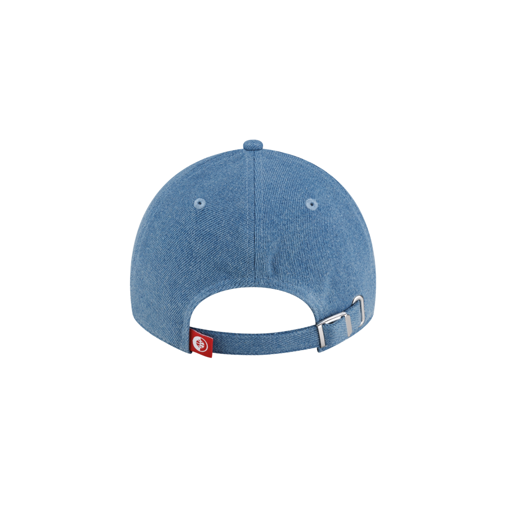 Back view of a blue denim Court Culture x New Era Retro Denim Dad Hat, featuring an adjustable silver metal buckle strap and a small red logo tag.