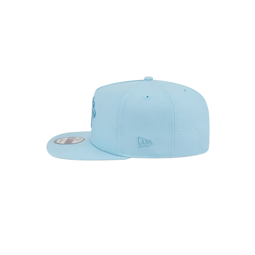 The New Era Miami HEAT Light Blue Color Pack Snapback, shown from a side angle on a white background, features a small embroidered logo near the back, a round visor sticker, adjustable fit, and is spot clean only.