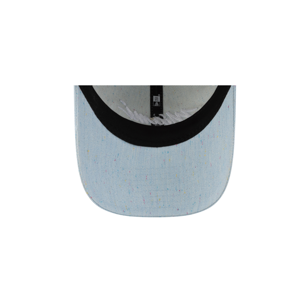 Close-up of the underside of the Court Culture Original Vice Nights Wordmark Dad Hat by Court Culture, featuring light blue cotton with multicolored specks, black inner trim, a glimpse of the interior, and a one-size-fits-most design.