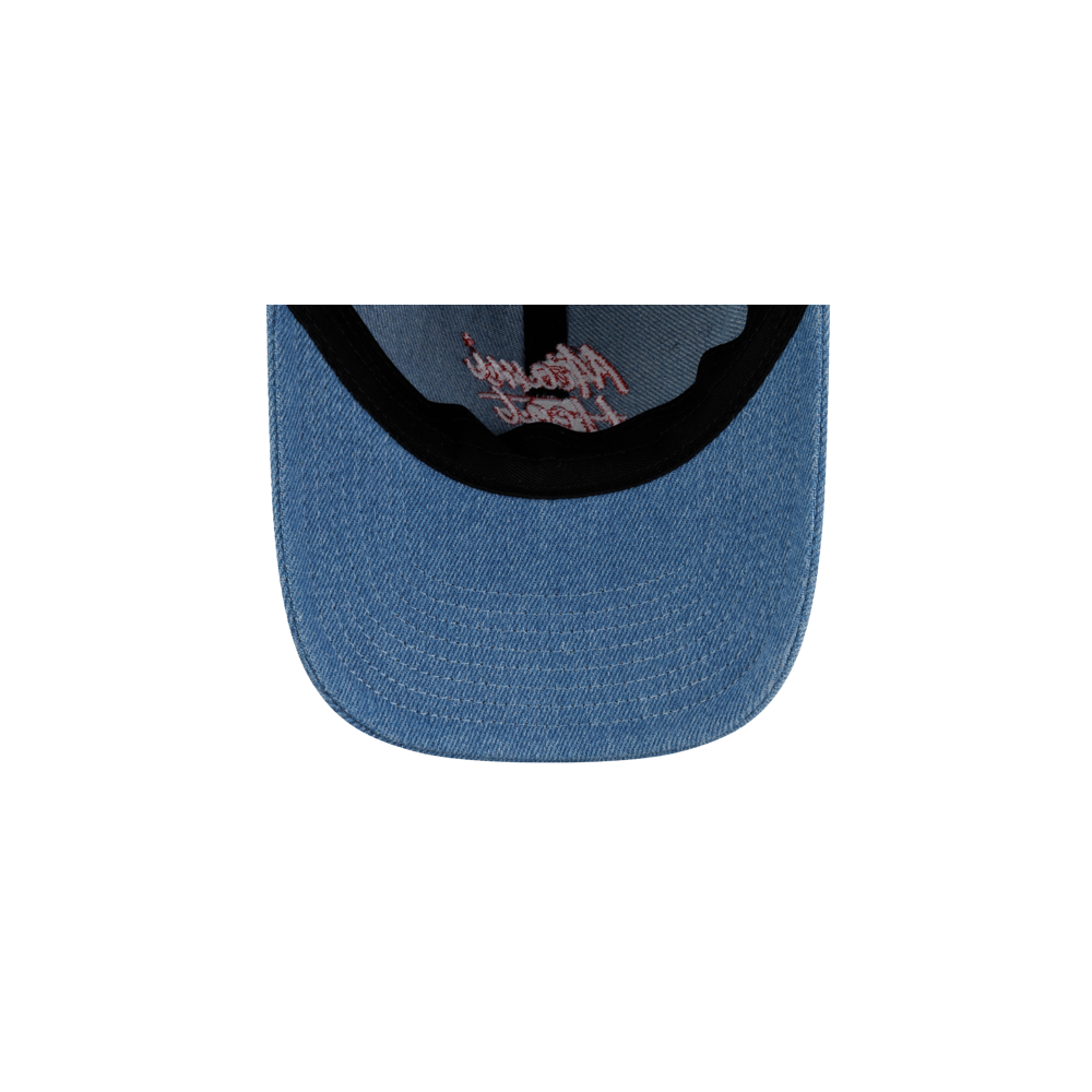 Close-up of a blue cotton Court Culture x New Era Retro Denim Dad Hat with red cursive embroidery on the front panel above the brim, featuring a one size fits most design.
