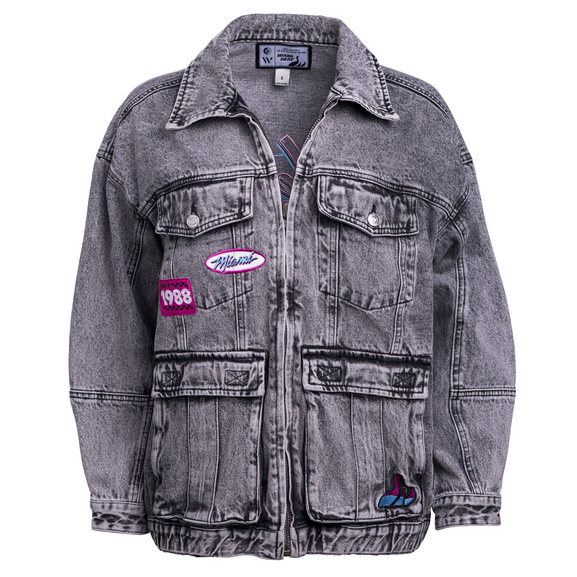 The Court Culture X The Wild Collective Original Vice Nights Denim Patch Unisex Jacket is a gray acid-washed cotton standard-fit piece with four front pockets, colorful patches—1988 and Wildcat—a collar, button closure, and dry clean only care.