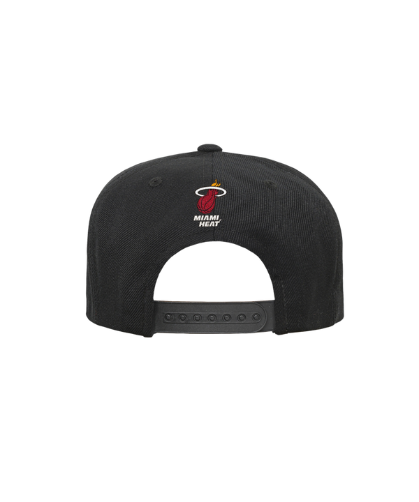 The Outerstuff Miami HEAT Logo Youth Flatbrim Snapback features a black polyester design with the team's red flaming basketball logo on front. One size fits most and easy to spot clean, shown against a plain white background.