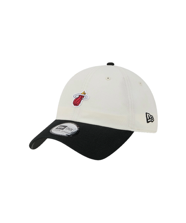 The New Era Miami HEAT 2-Tone Micro Dad Hat is a white and black cotton cap featuring the Miami Heat logo on the front and the New Era logo on the side, displayed against a white background. Designed for casual wear, this one-size-fits-most hat ensures comfortable everyday use.