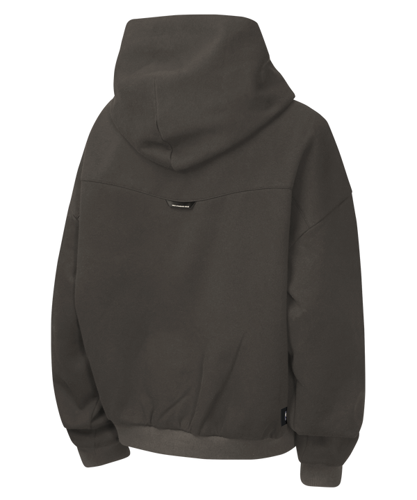The Nike Miami HEAT Oversized Fleece Travel Youth Hoodie is a dark gray, loose-fit hoodie made from a soft cotton-polyester blend, featuring bold black “MIAMI” lettering across the chest and a convenient front kangaroo pocket.