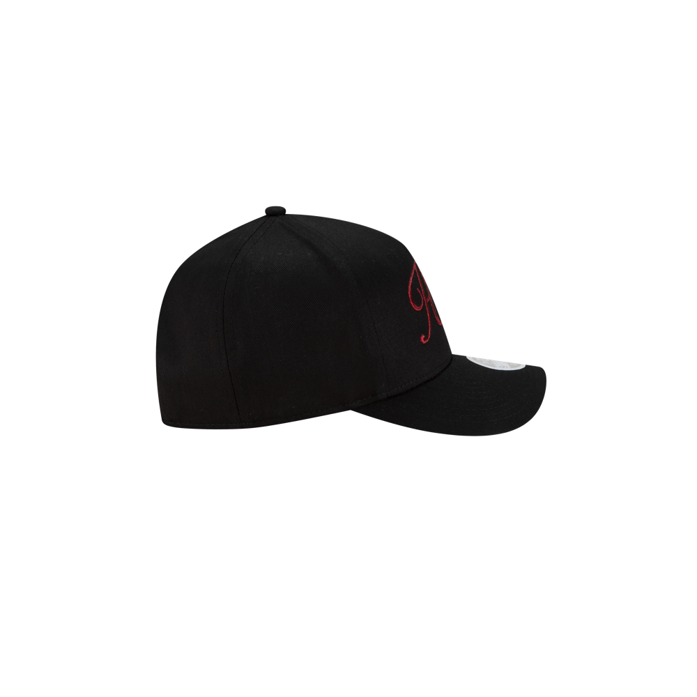 A side view of the black New Era Miami HEAT Metallic Women's Hat, showing red front embroidery and a white brim sticker, against a plain white background.