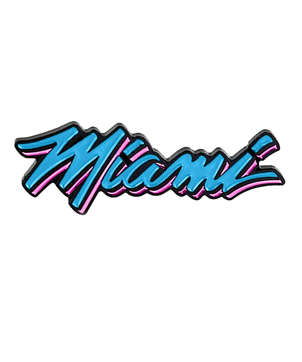 The Aminco Miami HEAT Original Vice Nights Wordmark Pin features “Miami” in bold blue cursive outlined in black and pink, inspired by retro neon signs. This officially licensed pin measures approximately 1 1/2