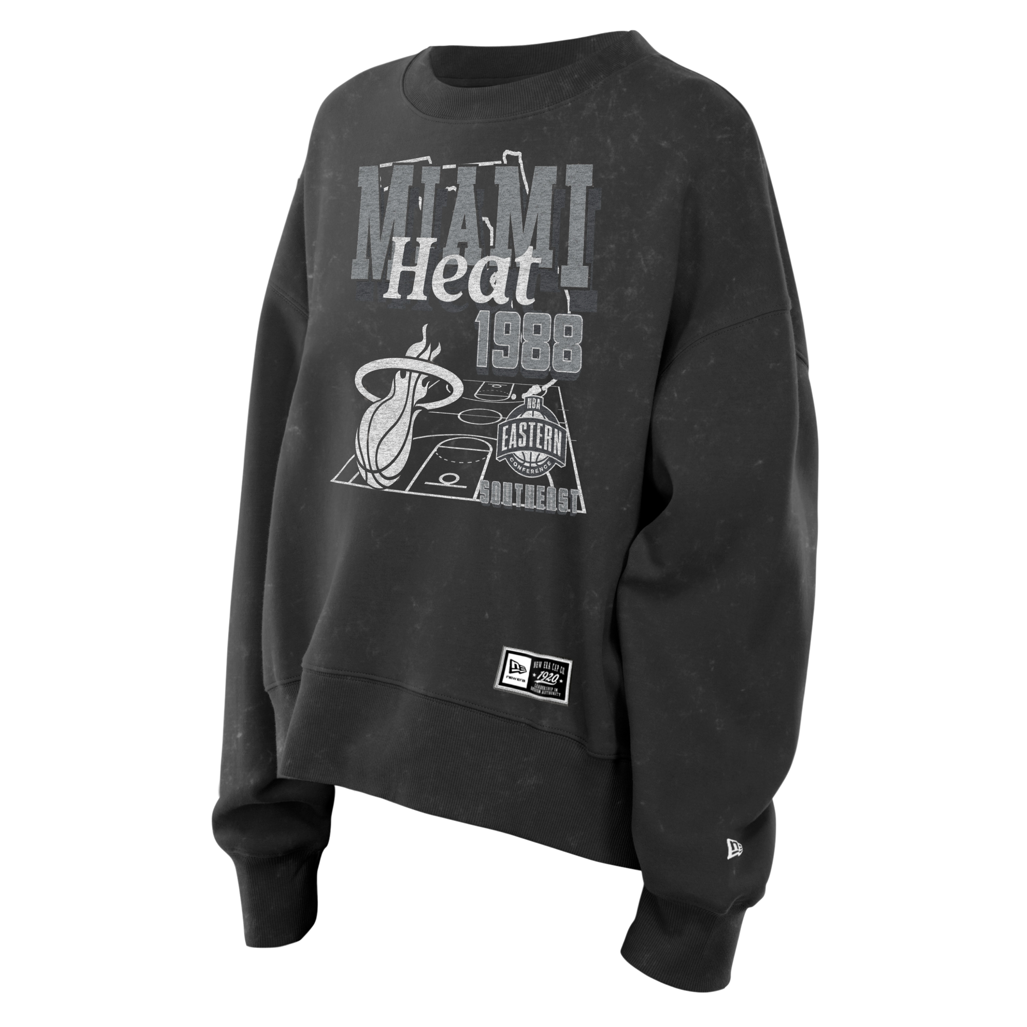 The New Era Miami HEAT Mineral Wash Women’s Crewneck is a black sweatshirt featuring MIAMI Heat 1988 text, basketball court graphics, and team logos on the front. Crafted from a soft cotton-polyester blend with a trendy cropped relaxed fit, this New Era crewneck is displayed on a plain white background.
