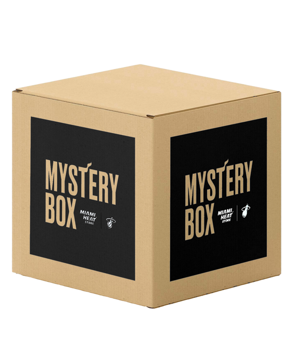 A brown cardboard box with black labels on two sides displays “Miami HEAT Original Vice Mystery Box - Men’s” and the Miami Heat logo in white, from the Miami HEAT Store.