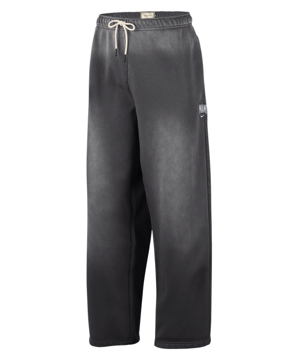 Loose-fitting black Nike Miami HEAT Standard Issue Washed Pants featuring a white drawstring at the waist, subtle fading throughout the fabric, and a small white Nike logo with NOCTA branding on the left thigh, displayed against a plain white background.