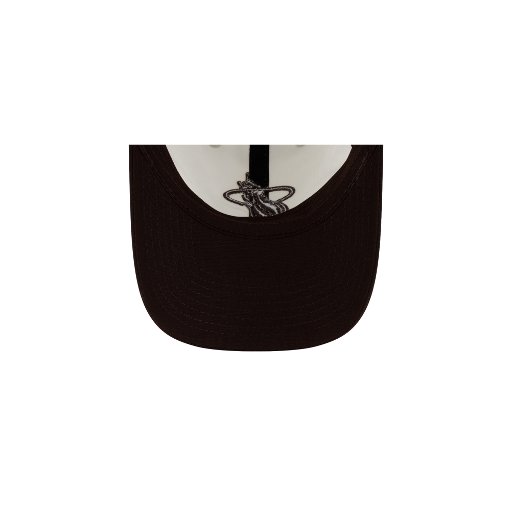 Under-brim view of a dark brown polyester Court Culture x New Era Café y Leche Dad Cap featuring an embroidered graphic of a coffee cup on the interior crown.