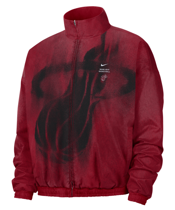 Red, loose-fit Nike Miami HEAT Standard Issue Loud Woven Jacket with a full-zip closure and a black spray-paint-style team logo on the chest, including a small logo, swoosh, and MIAMI HEAT BASKETBALL text.