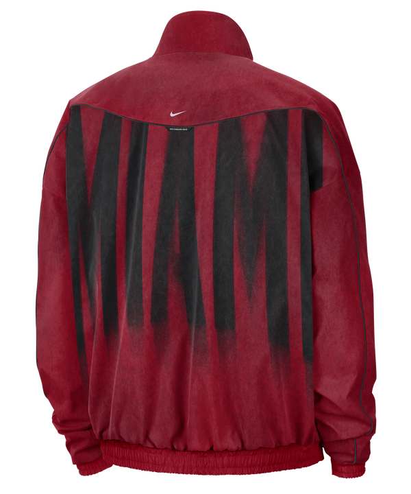 Red, loose-fit Nike Miami HEAT Standard Issue Loud Woven Jacket with a full-zip closure and a black spray-paint-style team logo on the chest, including a small logo, swoosh, and MIAMI HEAT BASKETBALL text.
