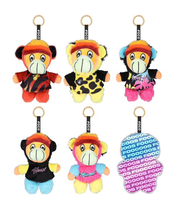 A purple Miami HEAT Burnie Foocoos Plushie Keychain Blind Box by Forever Collectibles features a mystery figure silhouette and showcases six plush keychain bag charm designs displayed on the side panel.