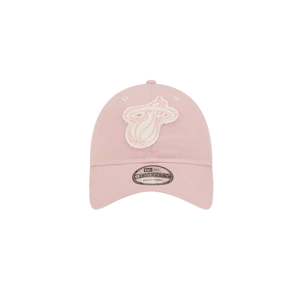 The New Era Miami HEAT Pink Stamp Dad Hat features a light pink cotton design with a white and pink embroidered team logo, adjustable strap, and brim sticker. One size fits most; spot clean to maintain its fresh look.
