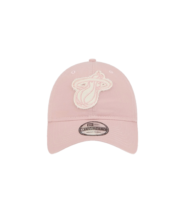 The New Era Miami HEAT Pink Stamp Dad Hat features a light pink cotton design with a white and pink embroidered team logo, adjustable strap, and brim sticker. One size fits most; spot clean to maintain its fresh look.