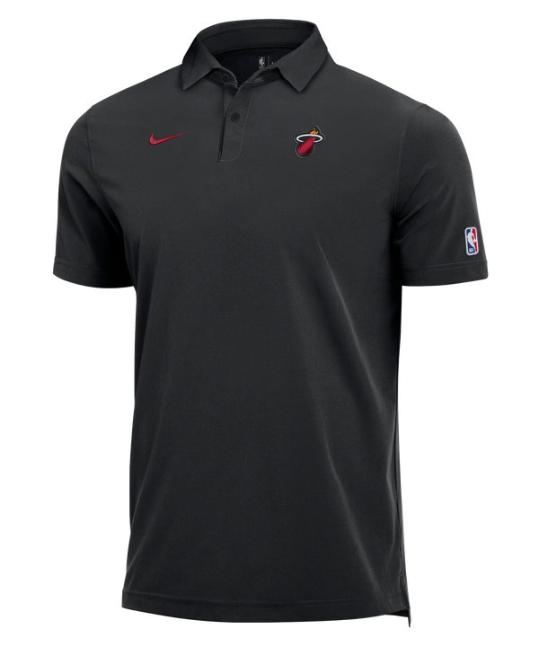 The Nike Miami HEAT Staff Polo features the Miami Heat logo on the left chest, a red Nike Swoosh on the right chest, and the NBA logo on the right sleeve. Crafted from a comfortable polyester-spandex blend with Dri-FIT technology for advanced moisture management, this standard-fit polo is shown on a plain white background.