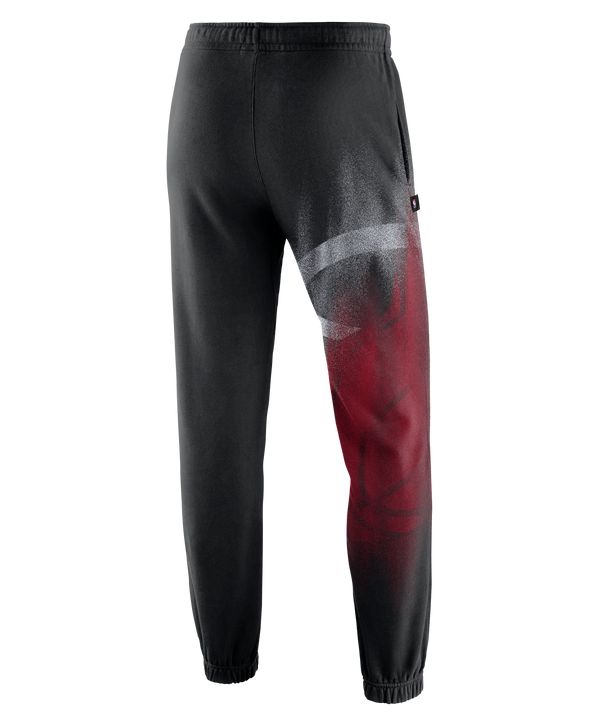 The Nike Miami HEAT Standard Issue Oversized Logo Fleece Pants feature a black design with a white drawstring and an elastic waistband. These pants showcase a large, colorful Miami HEAT basketball team logo on the left leg and a small white Nike Swoosh on the right thigh. Designed by Nike for a loose fit, they combine comfort and style for everyday wear.
