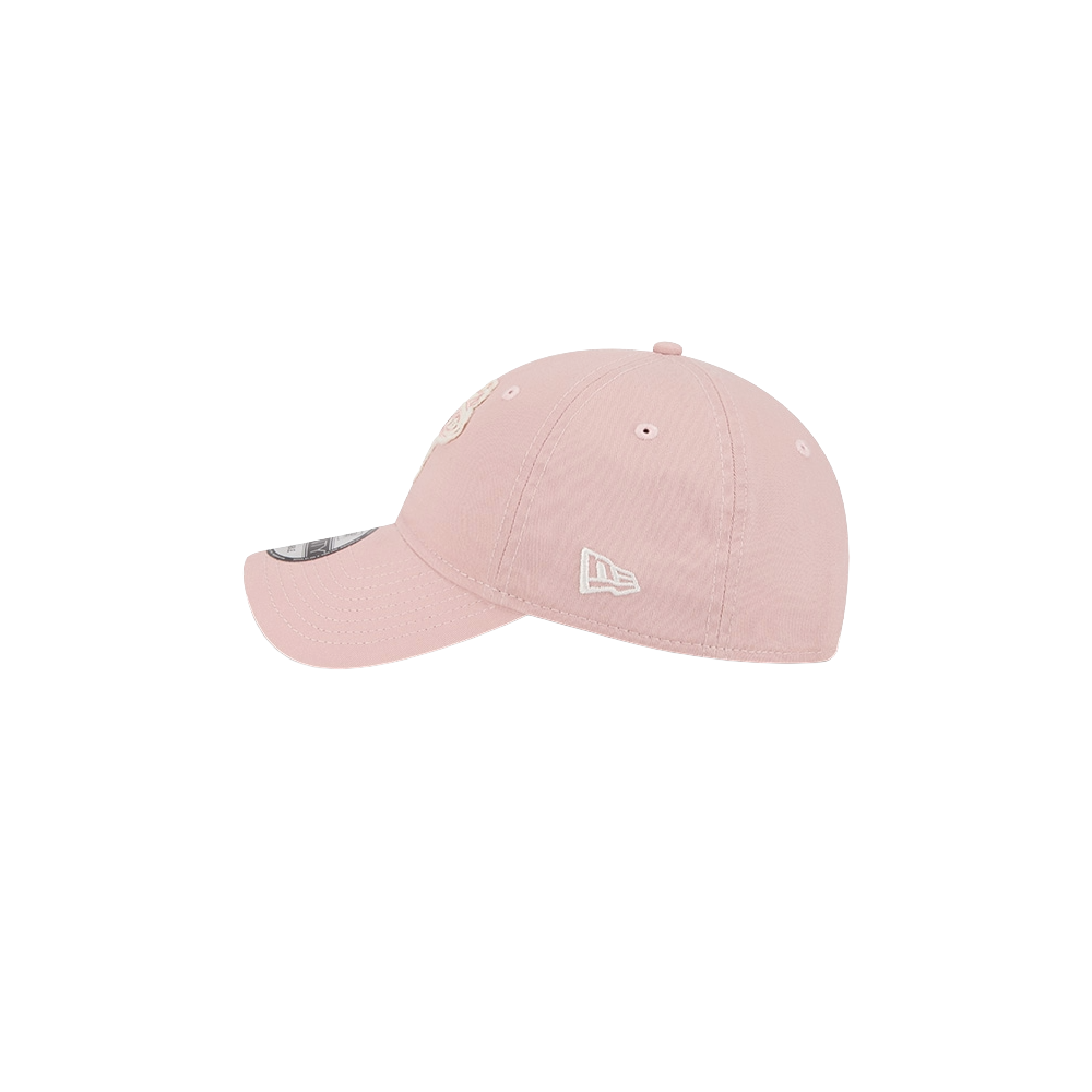 The New Era Miami HEAT Pink Stamp Dad Hat is light pink cotton with a curved brim, white embroidered logos on the side and front, and a plain white background. One size fits most; spot clean. Brand: New Era.
