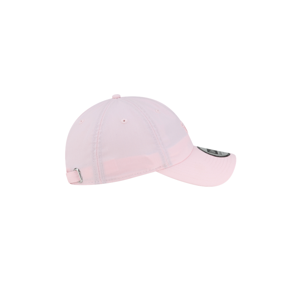 Side view of a light pink Court Culture x New Era Breast Cancer Awareness Dad Hat, featuring an adjustable strap and a small circular logo on the brim.