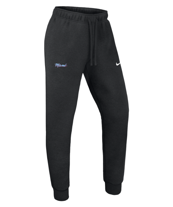 Nike Miami HEAT Original Vice Nights Women's Pants feature a standard fit, mid-rise design with an elastic waistband, drawstring, cuffed ankles, “Miami” in colorful script on the left thigh, and a white Nike Swoosh on the right. Plain white background.