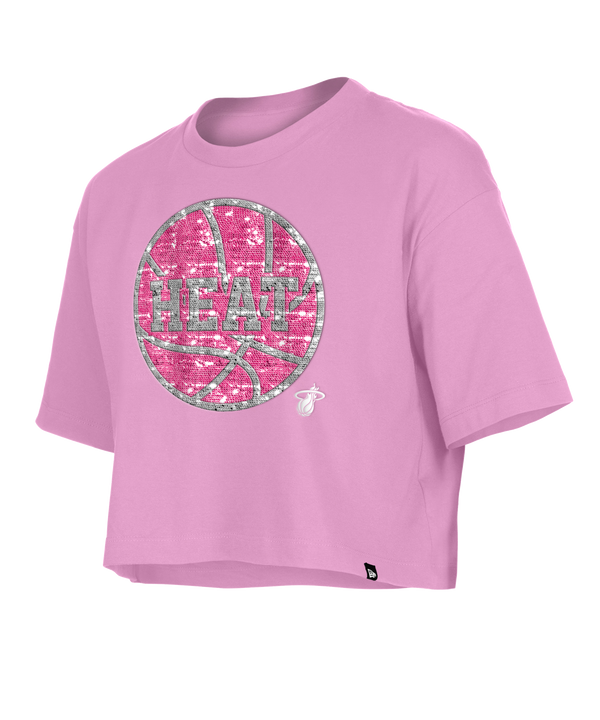 The New Era Miami HEAT Basketball Sequins Girls Tee is a light pink, cropped cotton T-shirt with a glittery basketball graphic, HEAT lettering, and a Miami Heat logo. This standard fit tee is machine washable and perfect for a relaxed look.