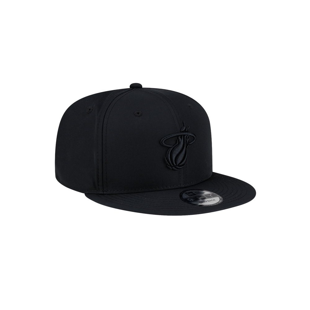 Court Culture x New Era Blackout Snapback featuring a black polyester design with a tonal Miami Heat logo on the front.