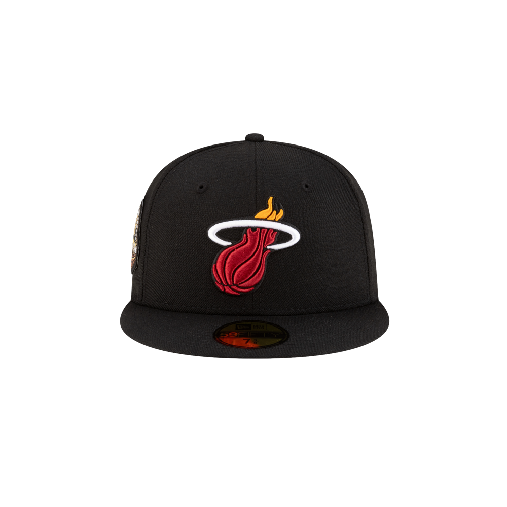 The New Era Miami HEAT 06' Ring Fitted Hat is a black wool flat-brim cap with the red, yellow, and white Miami Heat logo on the front. This fitted hat by New Era is shown against a plain white background. Spot clean only.