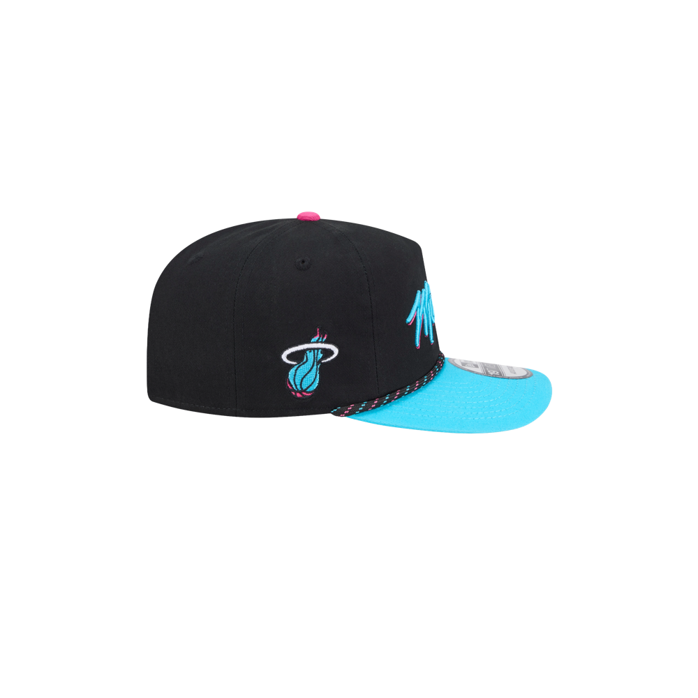 The New Era Miami HEAT Original Vice Nights Rope Snapback is a black and turquoise cotton hat with a pink top button, featuring the Miami Heat logo on the side. One size fits most; spot clean only. Shown from the side against a white background.