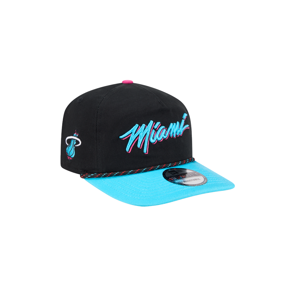 The New Era Miami HEAT Original Vice Nights Stretch Snapback features a black and turquoise design, “Miami” in blue and pink script on the front, team logo on the side, and a flat turquoise brim with sticker.