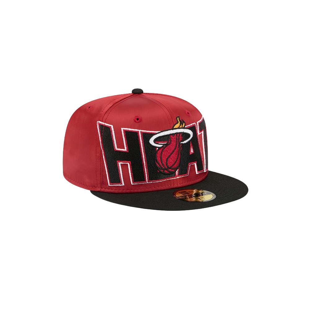 The New Era Miami HEAT Red Satin Fitted Hat features a bold HEAT logo with flaming basketball on the front, a black flat spandex visor with gold sticker, and easy spot-clean polyester for lasting style.
