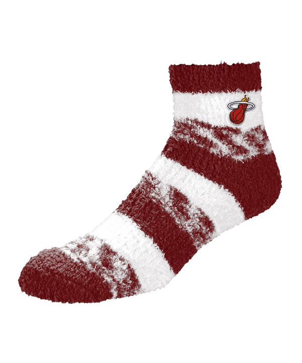 Slip into comfort with Miami HEAT Cozy Socks by For Bare Feet—women’s fuzzy, wide red and white striped socks featuring the team logo near the top, crafted from soft polyester for a textured look and standard fit.