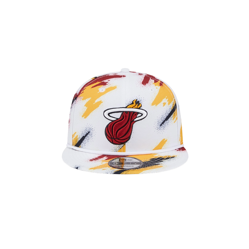 The New Era Miami HEAT Youth Paint Snapback features the team logo on white polyester with red, yellow, and black paint splatter accents. One size fits most; spot clean for best care.