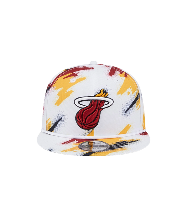 The New Era Miami HEAT Youth Paint Snapback features the team logo on white polyester with red, yellow, and black paint splatter accents. One size fits most; spot clean for best care.