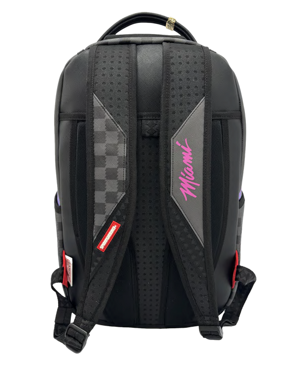 Introducing the Court Culture x Sprayground Miami HEAT Script Leather Backpack by Sprayground: This limited edition backpack showcases a black checkered design with “Miami” written in script at the top and a striking stylized shark mouth graphic in white, black, and purple on the front. For added functionality, it also features a laptop compartment for convenient organization.