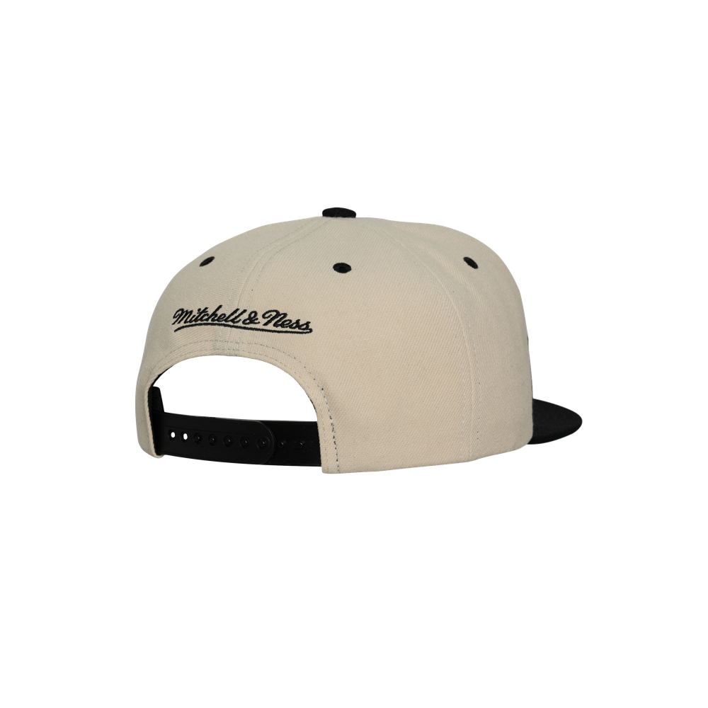 The Mitchell & Ness Miami HEAT Shark Tooth Snapback is a beige and black polyester hat, shown from the back with an embroidered Mitchell & Ness logo above the adjustable strap. One size fits most; spot clean only.
