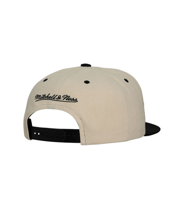 The Mitchell & Ness Miami HEAT Shark Tooth Snapback is a beige and black flat-brim polyester hat with a bold flame front, red and yellow team logo, NBA side patch, adjustable fit (one size fits most). Spot clean to maintain freshness.