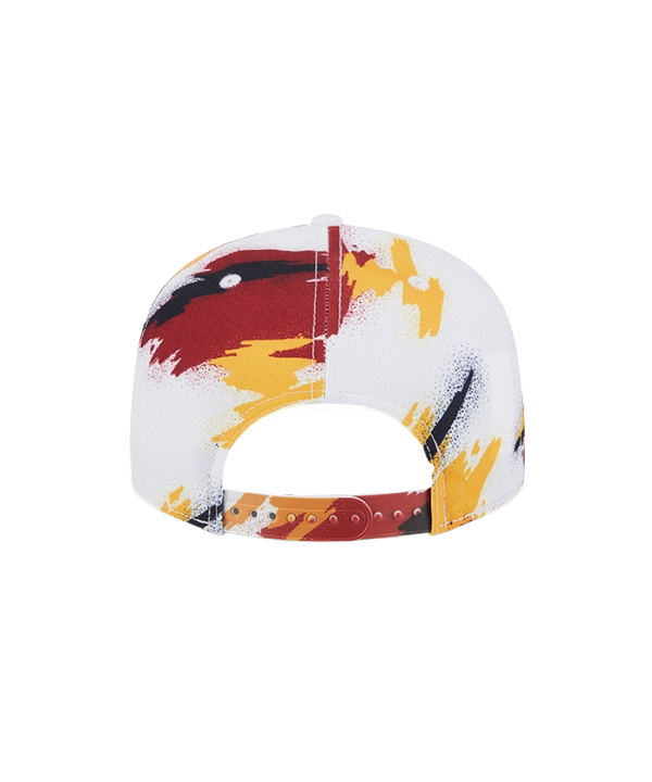 The New Era Miami HEAT Youth Paint Snapback features the team logo on white polyester with red, yellow, and black paint splatter accents. One size fits most; spot clean for best care.