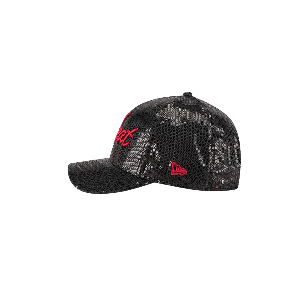 The New Era Miami HEAT Sequins Women’s Snapback is a black mesh baseball cap featuring silver sequins, camo pattern accents, and red embroidered logos on the side and front. Presented in profile against a plain white background, this one-size hat by New Era combines style and comfort and is easy to maintain—just spot clean as needed.